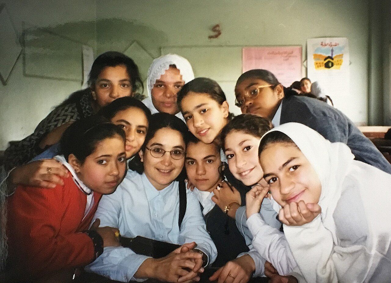 An anthropologist doing fieldwork inside a classroom in Cairo, observing everyday life