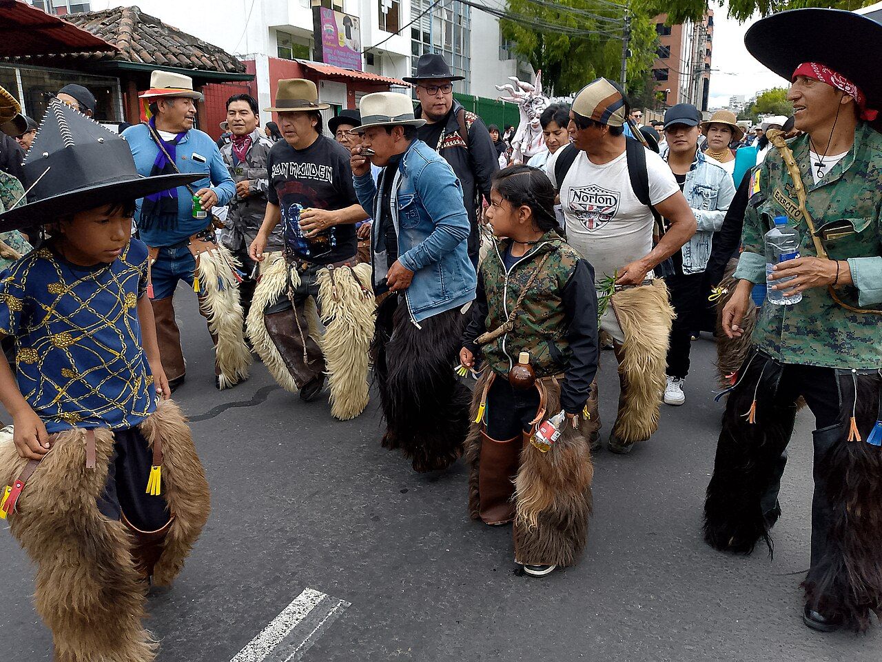Indigenous musicians and dancers performing at a festival in Ecuador