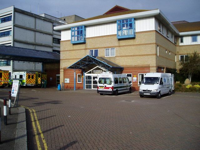 Hospital emergency department triage area with colored priority signage and staff at an intake desk