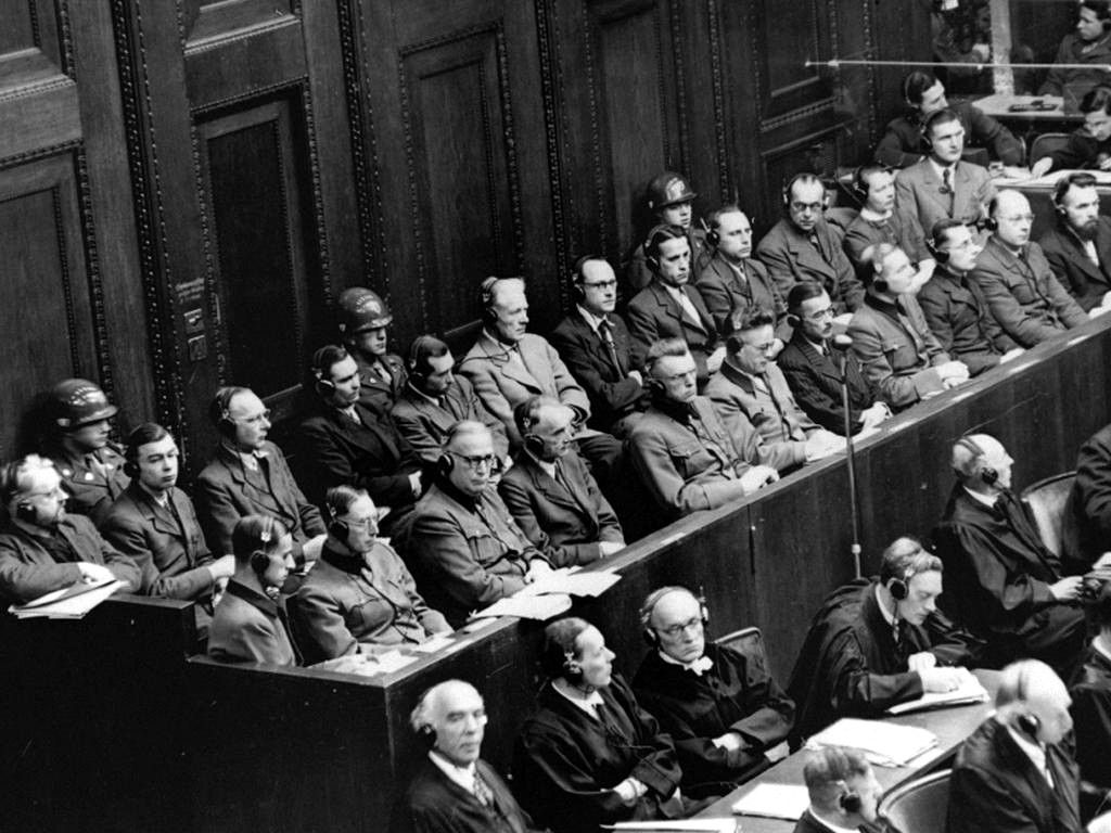 Defendants seated in the dock at the Nuremberg Doctors Trial in 1946, flanked by American military police