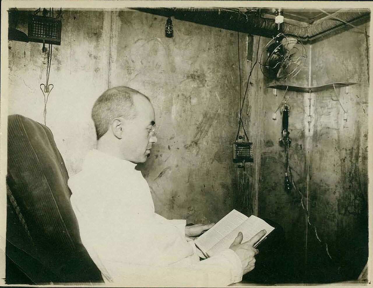 A person seated inside a sealed respiration calorimeter chamber used to measure human energy expenditure