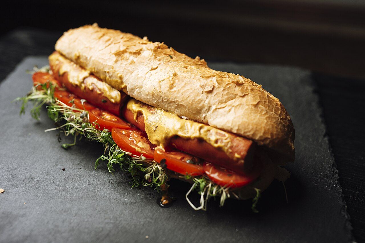 A sandwich made with whole grain bread and fresh vegetables