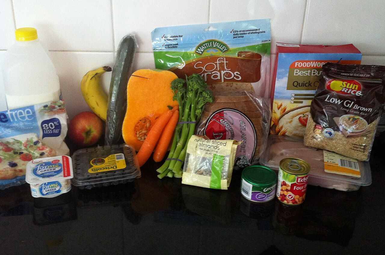 An assortment of vegetables, fruits, grains, legumes, dairy and protein foods arranged together