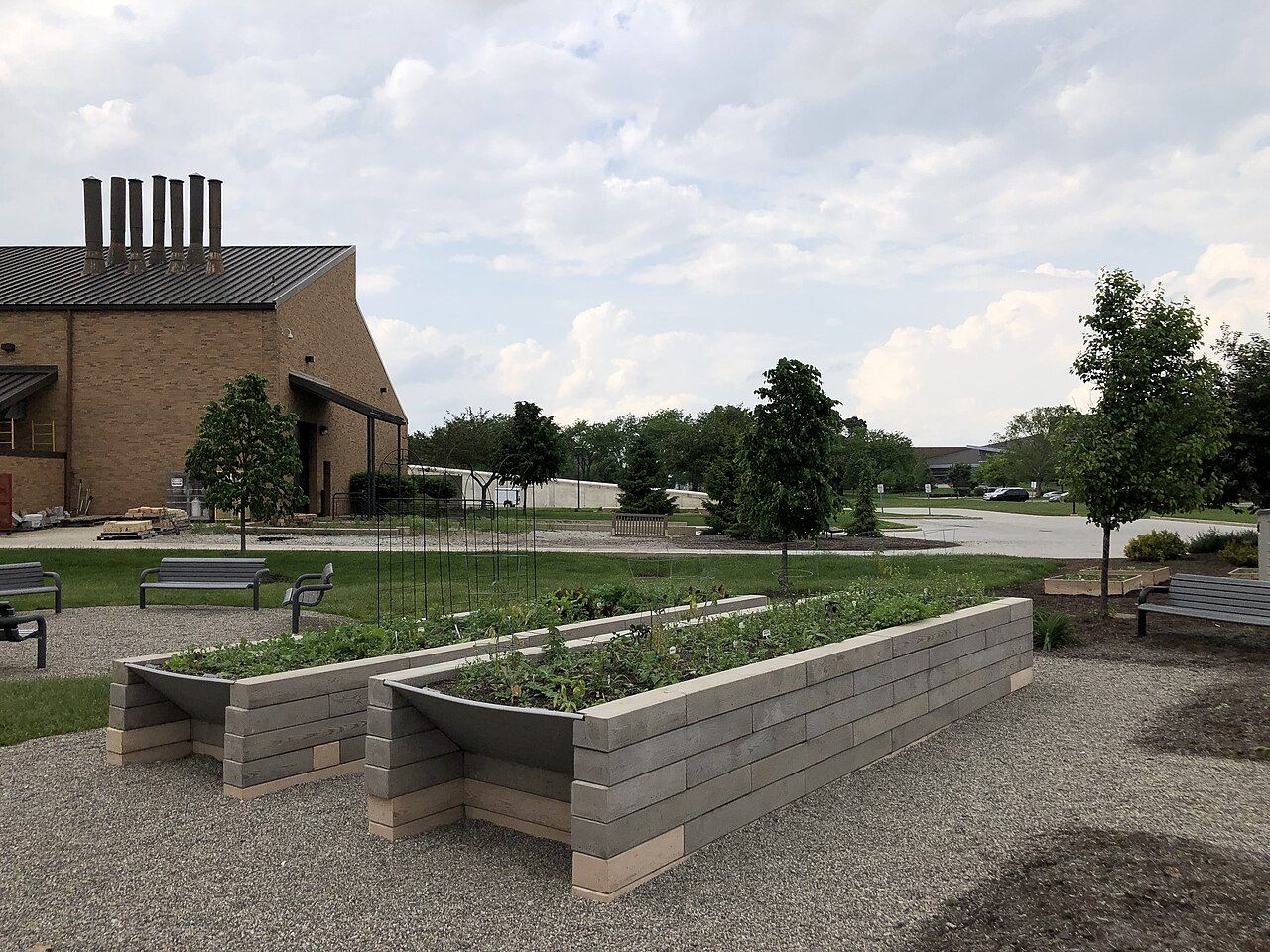 People tending raised planting beds in a community garden